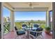 A serene outdoor balcony with comfortable seating and a gorgeous view of the water at 4801 Osprey S Dr # 404, St Petersburg, FL 33711