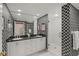 Stylish bathroom featuring patterned walls, modern vanity with double sinks, and glass-enclosed shower at 4801 Osprey S Dr # 404, St Petersburg, FL 33711