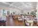 Spacious clubhouse featuring ample seating, wood-look flooring, coffered ceiling, and views of the beautiful lake at 4801 Osprey S Dr # 404, St Petersburg, FL 33711