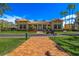 The charming clubhouse features a brick walkway, manicured lawns, and classic architectural details at 4801 Osprey S Dr # 404, St Petersburg, FL 33711