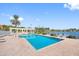 Community pool with brick deck, lake view, pergola, and plenty of seating, perfect for relaxing and enjoying the sun at 4801 Osprey S Dr # 404, St Petersburg, FL 33711