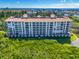 Beautiful large condo building with balconies and many windows for enjoying the serene lakeside views at 4801 Osprey S Dr # 404, St Petersburg, FL 33711