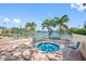 Community hot tub surrounded by palm trees and lake views, offering a serene retreat for relaxation and enjoyment at 4801 Osprey S Dr # 404, St Petersburg, FL 33711