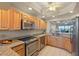Well-lit kitchen with stainless steel appliances, granite countertops, and ample cabinet space at 4801 Osprey S Dr # 404, St Petersburg, FL 33711