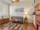 Comfortable living area with neutral colors, wood floors, and a view of the kitchen space at 4801 Osprey S Dr # 404, St Petersburg, FL 33711