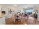An open-concept living room and dining area with hard wood floors and views of the water at 4801 Osprey S Dr # 404, St Petersburg, FL 33711