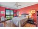 Bright bedroom with calming water views, hardwood floors, and neutral toned comforter at 4801 Osprey S Dr # 404, St Petersburg, FL 33711