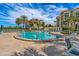 Outdoor pool surrounded by lounge chairs, palm trees, and luxury residential buildings at 4801 Osprey S Dr # 404, St Petersburg, FL 33711