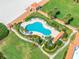 Aerial view features a clover shaped pool surrounded by lounge chairs, lawns, and walkways at 4801 Osprey S Dr # 404, St Petersburg, FL 33711