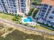 Aerial view showing a clover shaped pool surrounded by lounge chairs and two condos on a sunny day at 4801 Osprey S Dr # 404, St Petersburg, FL 33711
