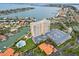 Wide aerial shot of condo building with pool, parking, and waterfront location at 4900 Brittany S Dr # 205, St Petersburg, FL 33715