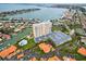 Stunning aerial view of waterfront condo featuring lush landscaping, pool, and ample parking at 4900 Brittany S Dr # 205, St Petersburg, FL 33715
