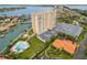 Stunning aerial view of the condo building with water views, a pool, and manicured grounds at 4900 Brittany S Dr # 205, St Petersburg, FL 33715