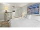 Serene bedroom with a white bed, neutral walls, decorative art, and ensuite bathroom access at 4900 Brittany S Dr # 205, St Petersburg, FL 33715
