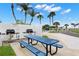 Community grill station featuring well-maintained grills, picnic tables, and scenic waterfront views at 4900 Brittany S Dr # 205, St Petersburg, FL 33715