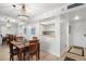 Dining room featuring a modern chandelier, seating for four, and an open view to the kitchen at 4900 Brittany S Dr # 205, St Petersburg, FL 33715
