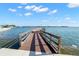 Wooden dock and walkway extending into the bay with views of nearby homes at 4900 Brittany S Dr # 205, St Petersburg, FL 33715