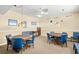 Carpeted game room with card tables and chairs under decorative pendant lights at 4900 Brittany S Dr # 205, St Petersburg, FL 33715
