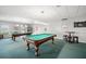 Spacious game room featuring pool tables, dart boards, and seating, perfect for entertaining and recreation at 4900 Brittany S Dr # 205, St Petersburg, FL 33715
