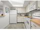 Bright kitchen with white appliances, ample cabinet space, and a tiled backsplash at 4900 Brittany S Dr # 205, St Petersburg, FL 33715