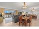 Charming living room with a decorative chandelier, a full wall mirror, and access to the balcony at 4900 Brittany S Dr # 205, St Petersburg, FL 33715