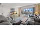 Bright living room featuring sliding glass doors to a balcony, sofa, and stylish decor at 4900 Brittany S Dr # 205, St Petersburg, FL 33715