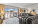 Living room with comfortable gray sofa, large windows to balcony, and decorative rug at 4900 Brittany S Dr # 205, St Petersburg, FL 33715