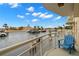 Open-air parking with ample spaces, palm trees, and blue skies, viewed from the condo's terrace at 4900 Brittany S Dr # 205, St Petersburg, FL 33715