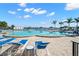 Community pool with blue lounge chairs and palm trees around the pool deck at 4900 Brittany S Dr # 205, St Petersburg, FL 33715