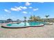 Large community pool overlooking the bay under a partly cloudy blue sky at 4900 Brittany S Dr # 205, St Petersburg, FL 33715