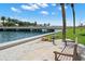 Waterfront seating area with benches and lush landscaping providing a serene spot to enjoy the scenic views at 4900 Brittany S Dr # 205, St Petersburg, FL 33715