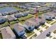 A high aerial view of a meticulously planned community with ponds and well-maintained lawns at 5764 Hollingworth Trl, Wesley Chapel, FL 33545