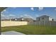 Fenced backyard with lush green grass, offering privacy and space for outdoor activities and relaxation at 5764 Hollingworth Trl, Wesley Chapel, FL 33545