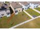 An aerial view of the backyard featuring a white fence, lush green grass and the home's exterior at 5764 Hollingworth Trl, Wesley Chapel, FL 33545