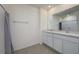 A well-lit bathroom features a shower-tub combo, double vanity and tile floors at 5764 Hollingworth Trl, Wesley Chapel, FL 33545