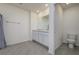 A bathroom with tiled floors and a double vanity with white cabinets at 5764 Hollingworth Trl, Wesley Chapel, FL 33545