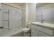 Bathroom with shower and single sink with storage cabinet at 5764 Hollingworth Trl, Wesley Chapel, FL 33545