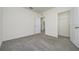 The carpeted bedroom offers ample space, complemented by an open closet and an attached bathroom for convenience at 5764 Hollingworth Trl, Wesley Chapel, FL 33545