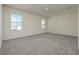 Spacious bedroom with neutral carpet, two large windows for lots of natural light at 5764 Hollingworth Trl, Wesley Chapel, FL 33545