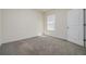 An ample bedroom with carpet and a window at 5764 Hollingworth Trl, Wesley Chapel, FL 33545