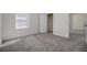 Sun-filled bedroom with carpet, a window and an open door at 5764 Hollingworth Trl, Wesley Chapel, FL 33545