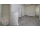 Carpeted open space with an open closet and a doorway into another room at 5764 Hollingworth Trl, Wesley Chapel, FL 33545