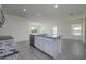 Open kitchen island view with stainless steel appliances, granite countertops, and a clear view of the living area at 5764 Hollingworth Trl, Wesley Chapel, FL 33545