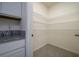 Walk-in pantry with multiple shelves and ceramic tile flooring next to the kitchen at 5764 Hollingworth Trl, Wesley Chapel, FL 33545