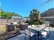 Backyard featuring a patio area with outdoor seating, lush greenery, and a barbecue grill at 5807 N Miami Pl, Tampa, FL 33604