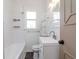 Bright bathroom featuring white subway tile, modern fixtures, and a shower/tub combo at 5807 N Miami Pl, Tampa, FL 33604