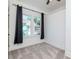 Inviting bedroom with large windows, dark curtains, and plush carpeting, creating a cozy and inviting space at 5807 N Miami Pl, Tampa, FL 33604