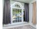 Detailed view of a bedroom window with elegant trim, complemented by stylish curtains and a view of the outdoors at 5807 N Miami Pl, Tampa, FL 33604