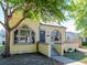 Exterior view of a charming home with arched windows, and a well-maintained front yard at 5807 N Miami Pl, Tampa, FL 33604