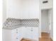 Modern kitchen featuring white cabinets, granite countertops, and view to dining area at 5807 N Miami Pl, Tampa, FL 33604